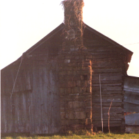 Chimney view of the log house before it was moved.
