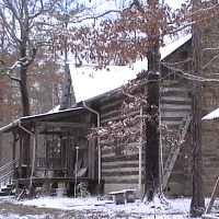 Snow on the log house.